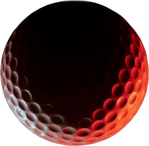 Close-up of a red-tinted golf ball with visible dimples.